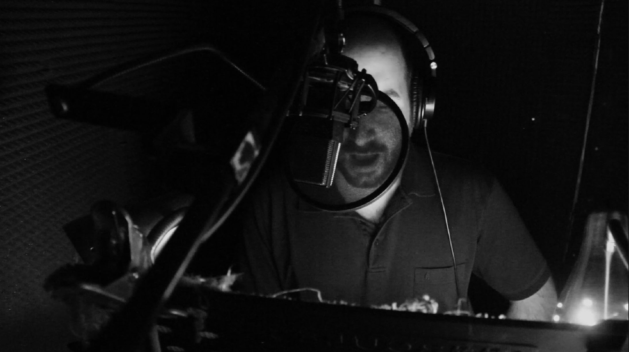 Professional VO talent in studio recording corporate presentation.